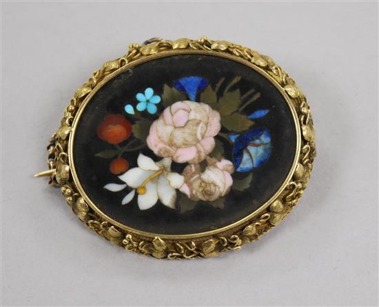 A late Victorian yellow metal and pietra dura oval brooch, decorated with flowers, 47mm.